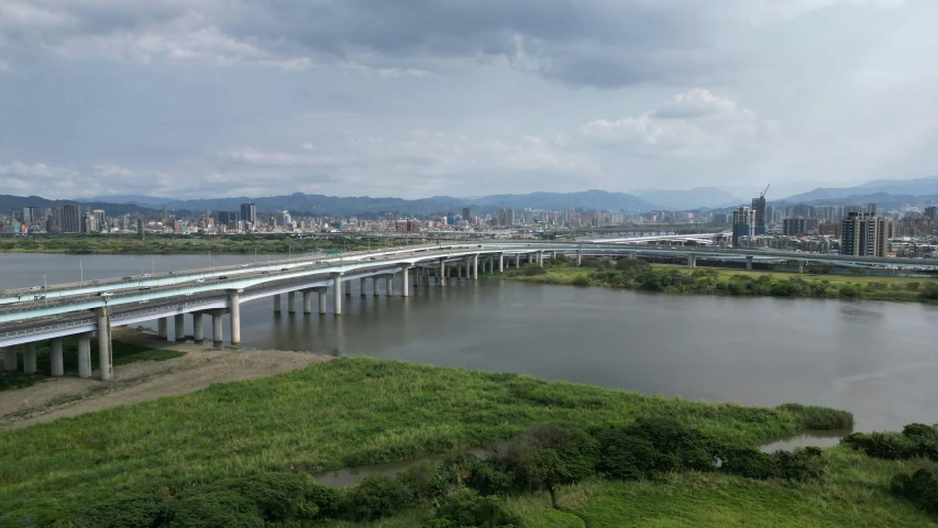 a large long bridge crossing over a large lake