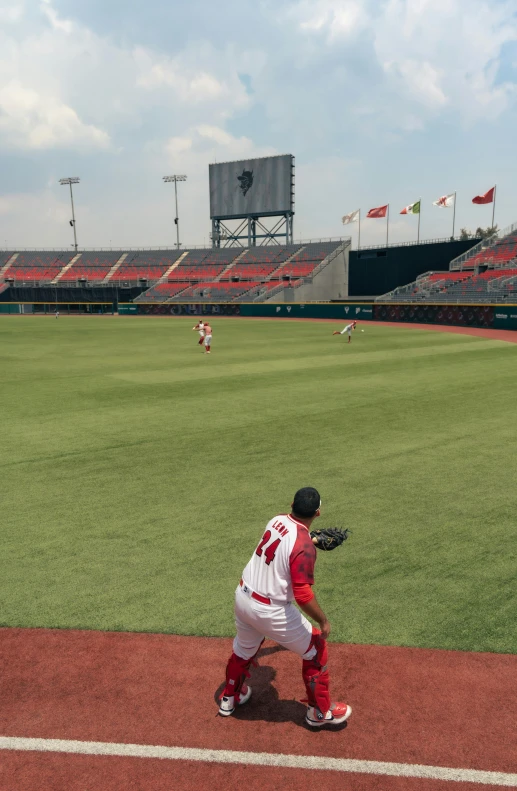 a man in white and red uniform standing on a baseball field