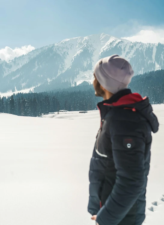 a man with a dog looking at a mountain