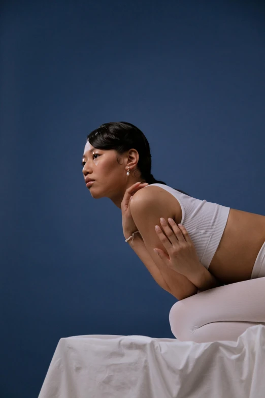 woman laying down with knees up on table