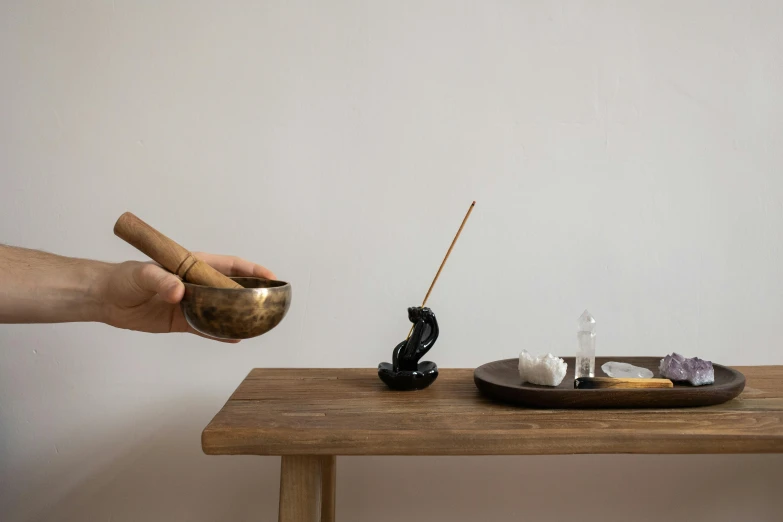 a person that is holding soing in front of a bowl