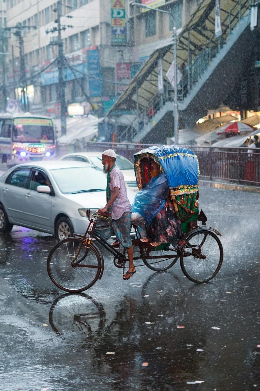 a man hing a cart filled with people through the rain