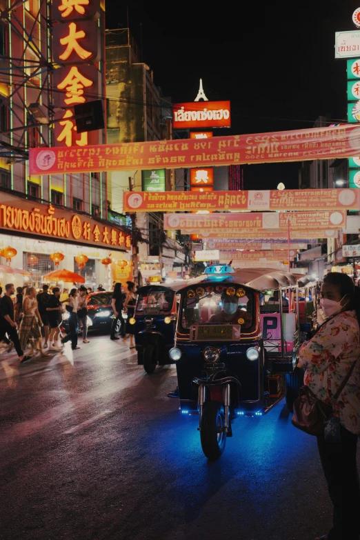 a city street filled with lots of cars next to tall buildings