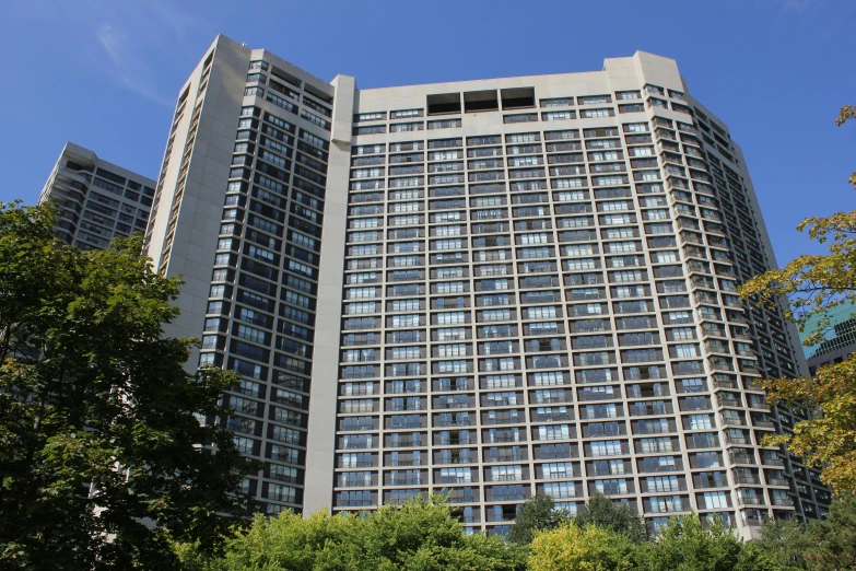 the building is near many trees and a clear blue sky