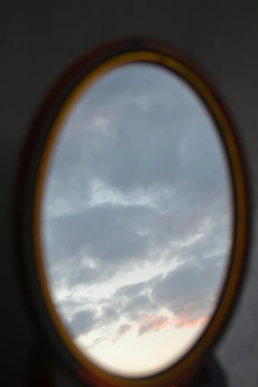 a mirror reflecting the sky and clouds on it