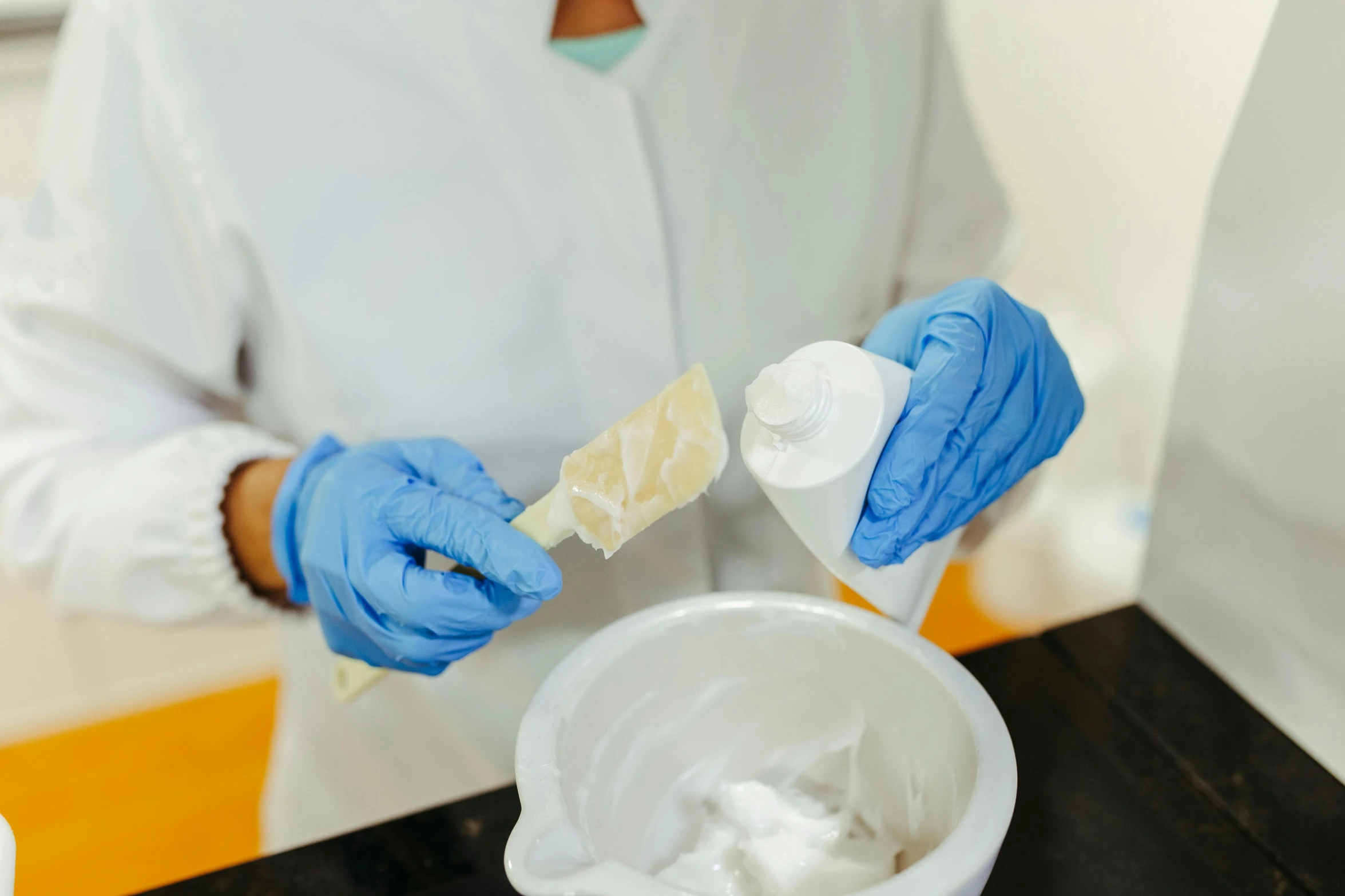 a woman in a kitchen cleaning her hands with a sponge