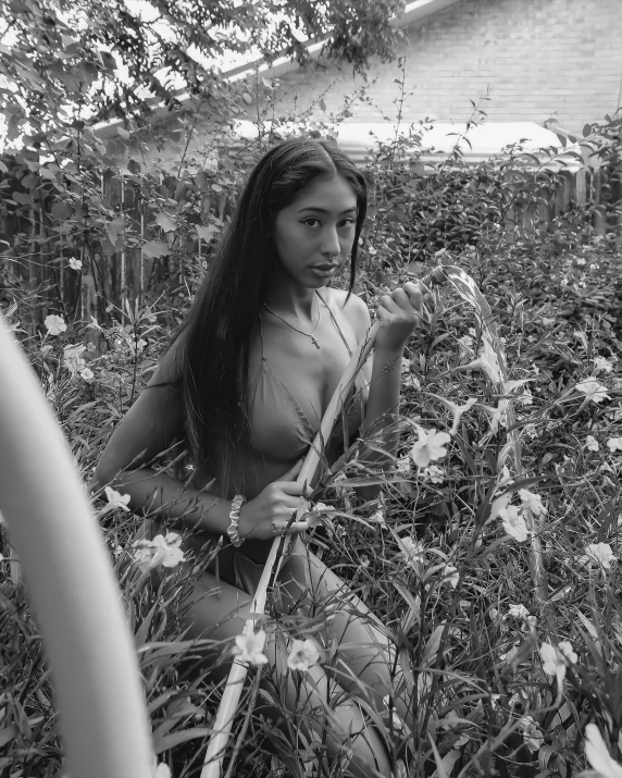 a women in some grass holding a whip blade