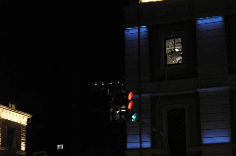 a street light with a large building in the background