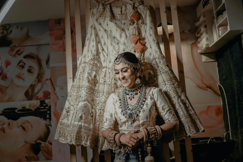 a woman dressed in an indian bridal posing for a po