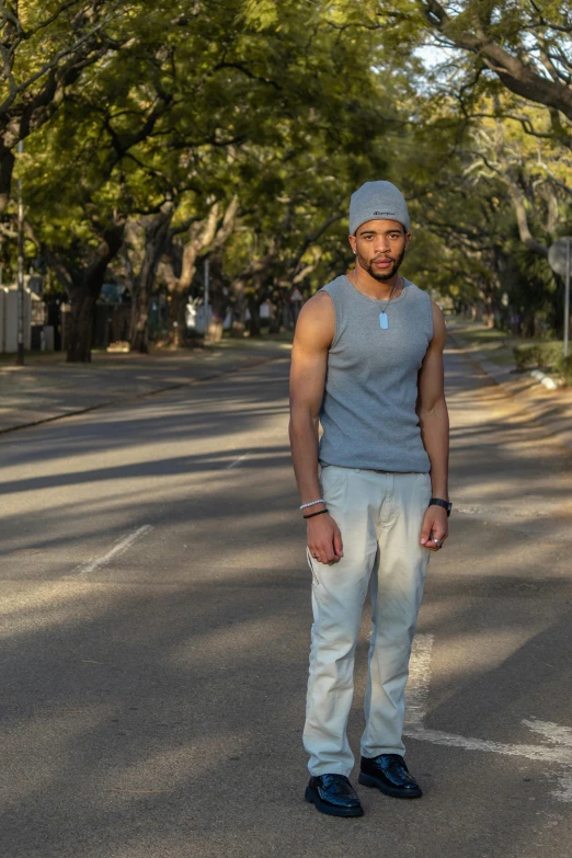 a man with a beard is standing in the street