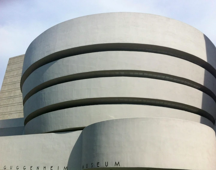 a modern building made of concrete with some curved curves