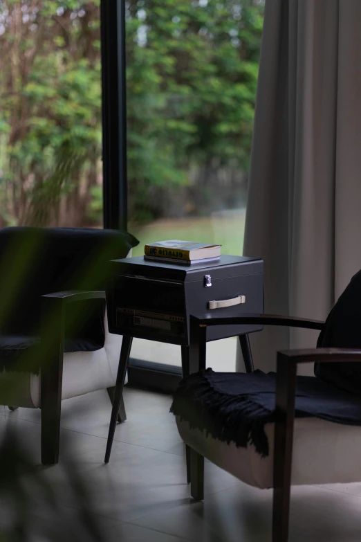 a white chair sits next to an open window