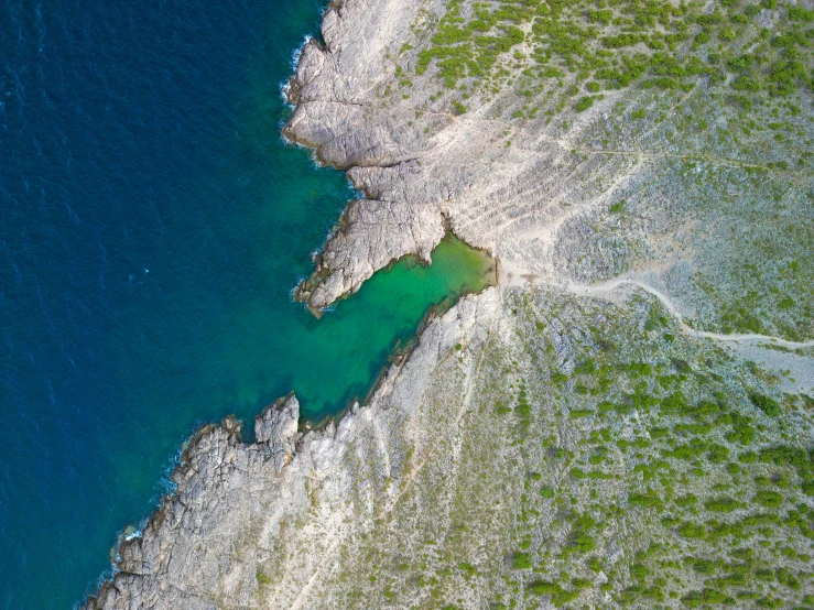 a body of water surrounded by green grass