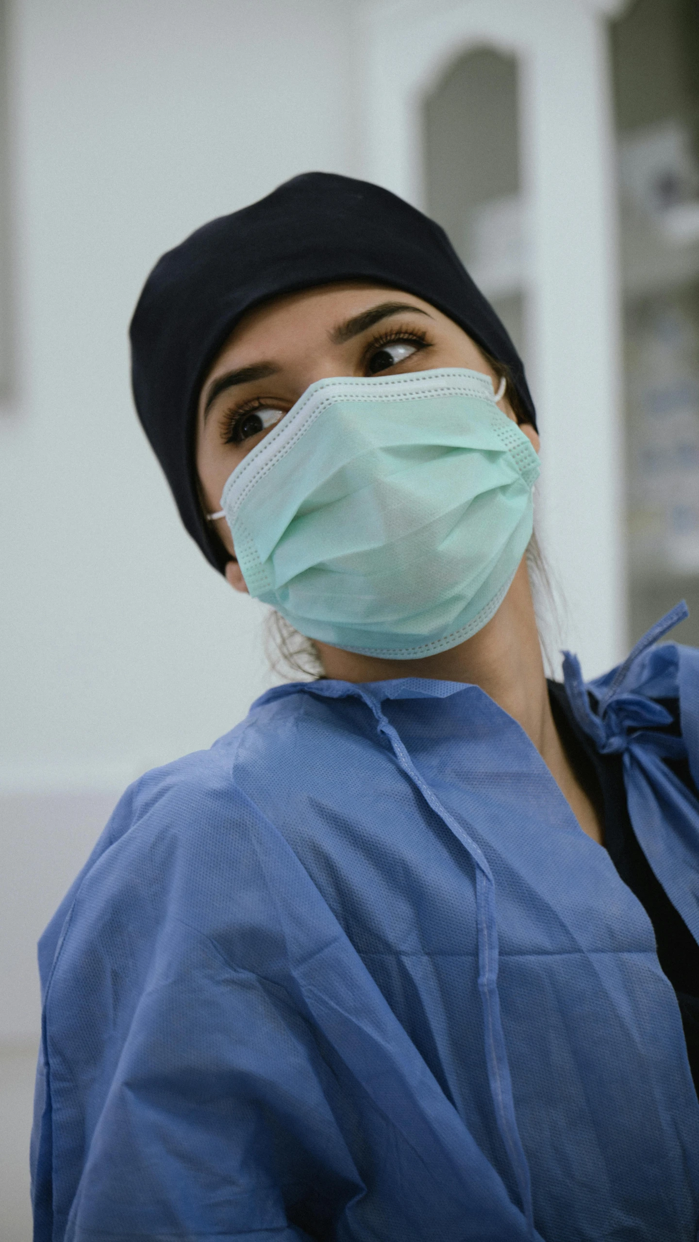 a woman wearing surgical mask and scrub on her head