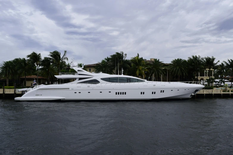 a white boat is sitting on the water