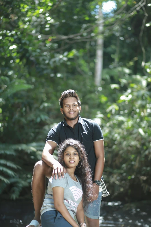 two people that are sitting together on some logs