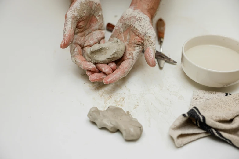 someone is making pottery on the counter next to their dish