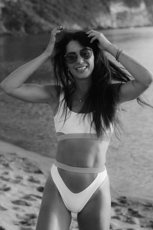 woman standing on a beach wearing a bikini