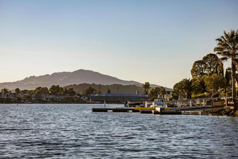 there are several different boats docked by the shore