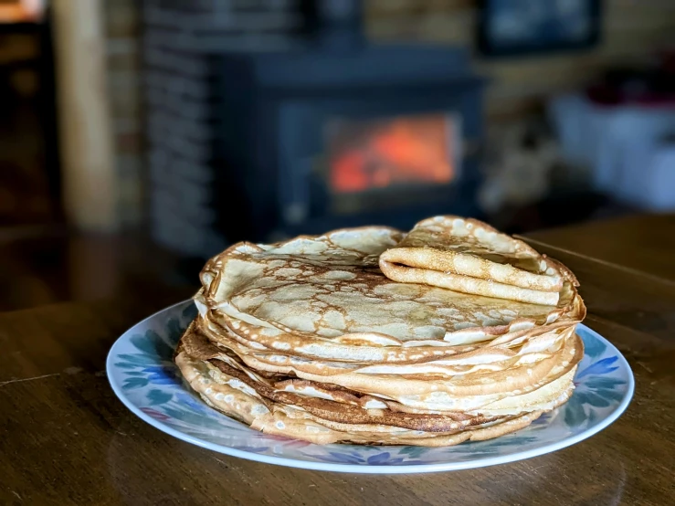 a stack of pancakes on a plate on a table