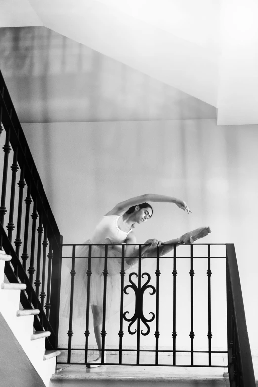 a black and white po of a woman on the stair way