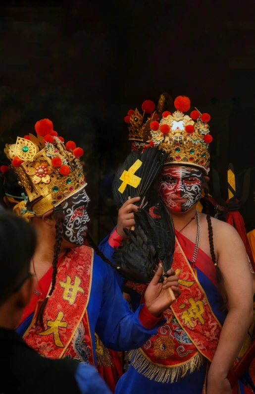 a man in a cross and other asian dancers