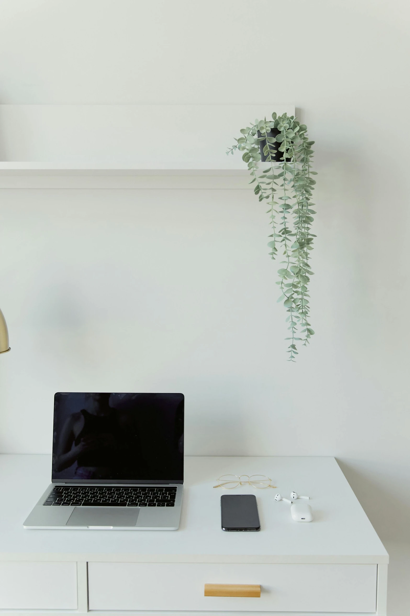 a desk with a laptop on top of it