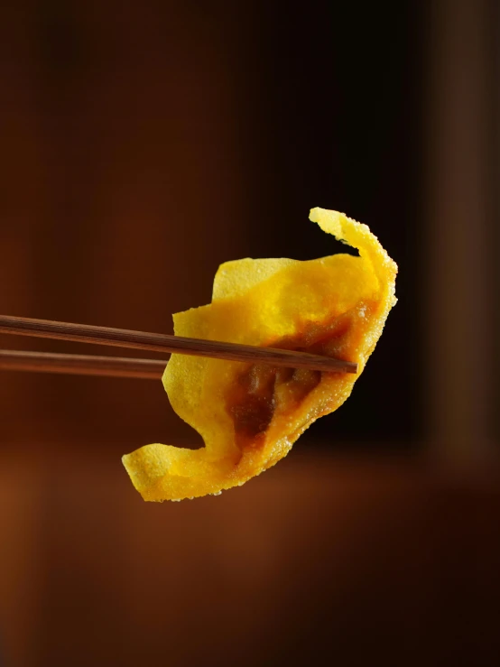 a closeup view of some noodles being held by chopsticks