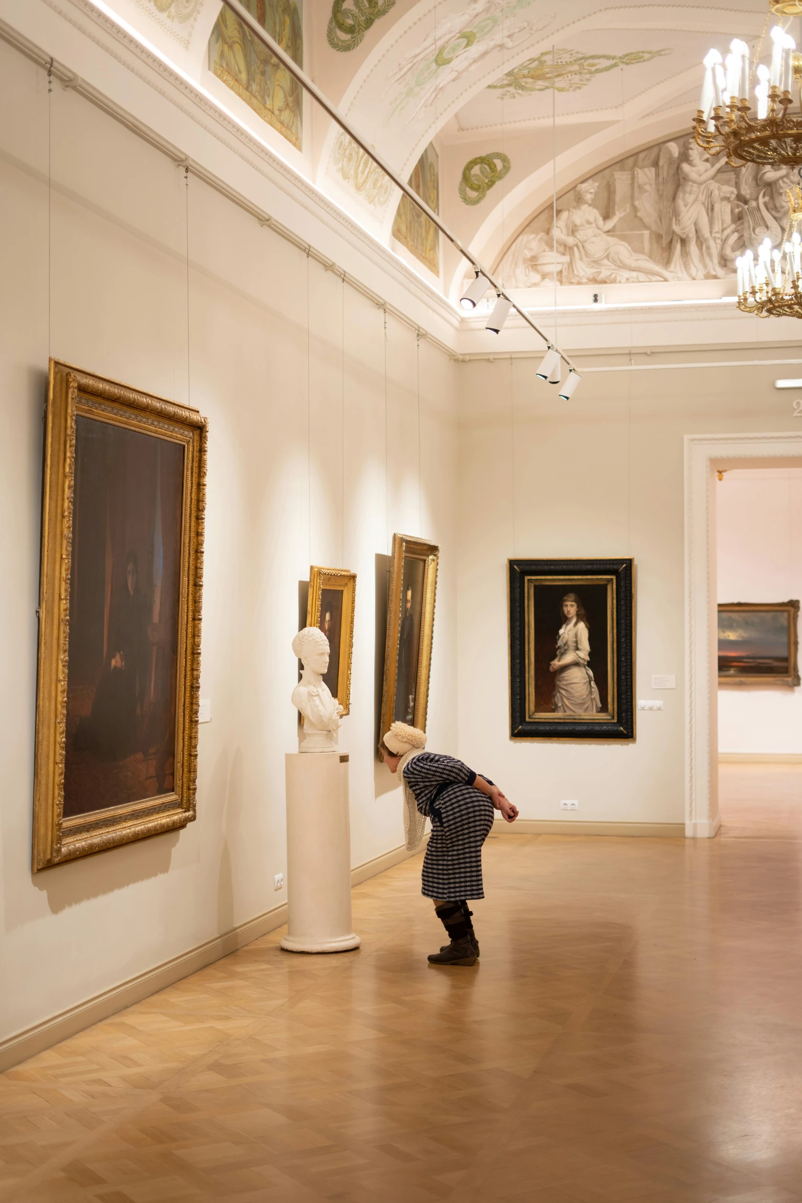 a boy is standing in front of some paintings