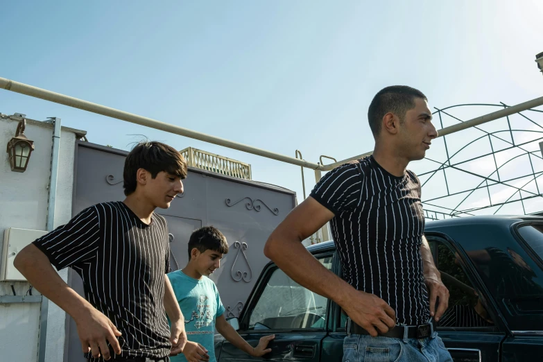 two men standing in front of a truck talking