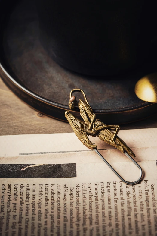 a small paper clip is sitting on top of an open book