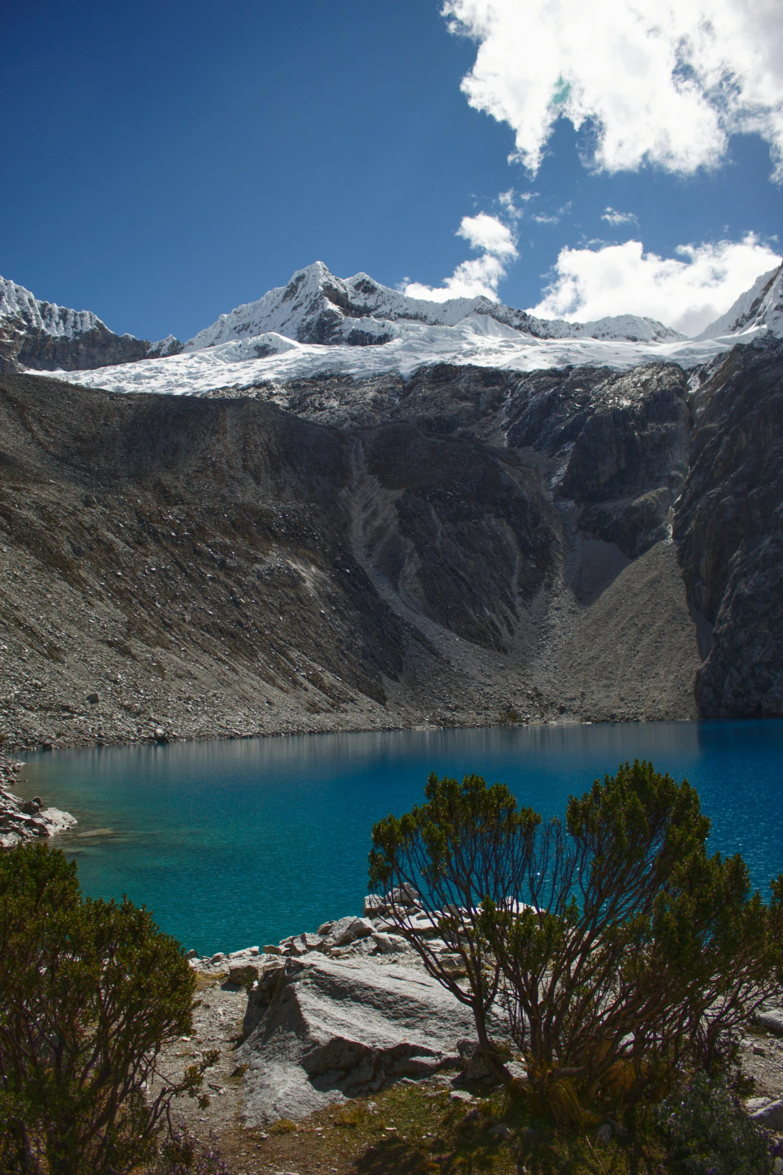 snow on the mountains surrounding a body of water