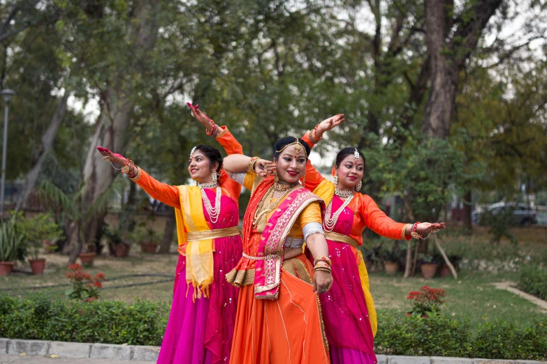 four women performing a dance trick in an indian village