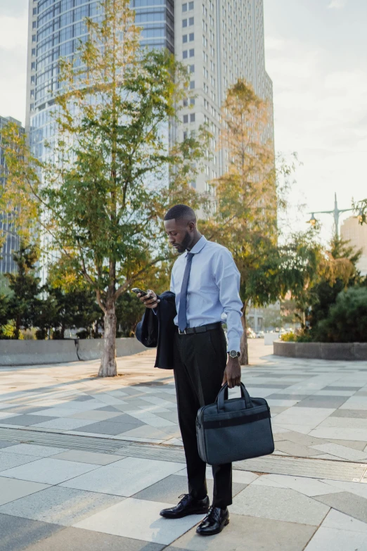 a businessman in formal wear stands in a courtyard