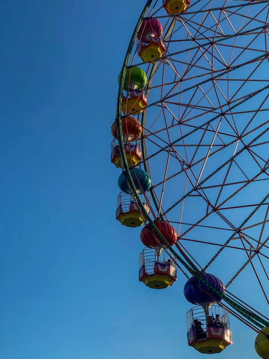 several carnival rides are shown with colorful wheel