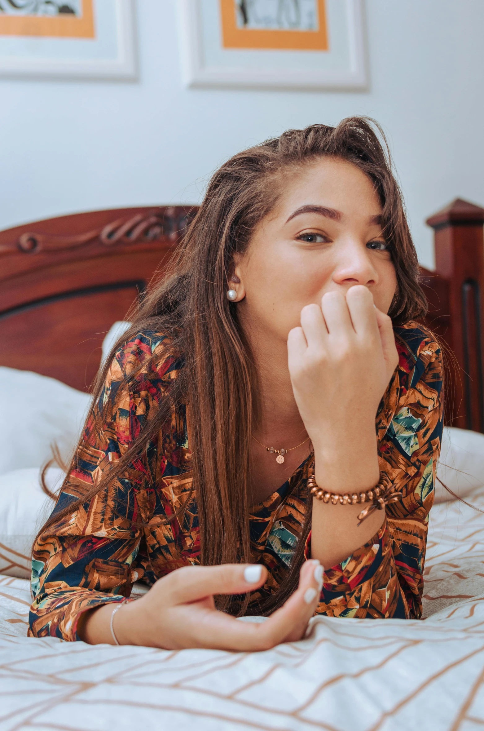 a woman laying on her side in bed looking away