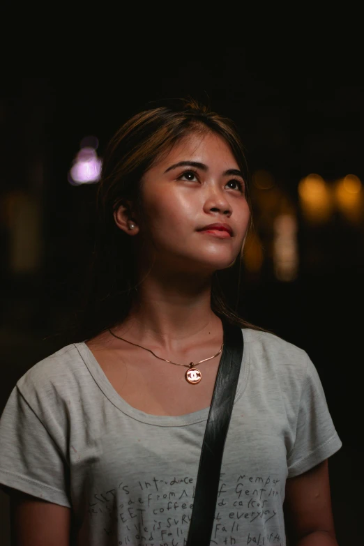 girl in the dark with her lanyard around her neck