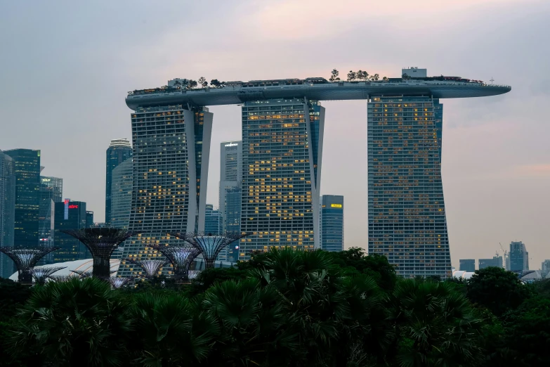 a city skyline with a few buildings, but some trees and lights