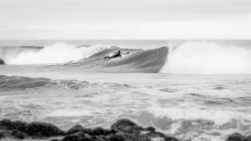 a surfer rides on a huge wave in the ocean