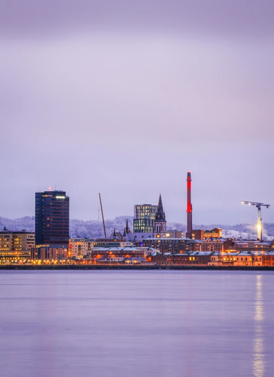 a large body of water with buildings in the background