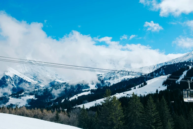 the mountain has some clouds in the sky