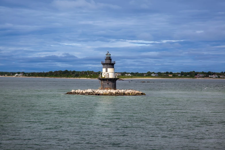 a light house in the middle of the water