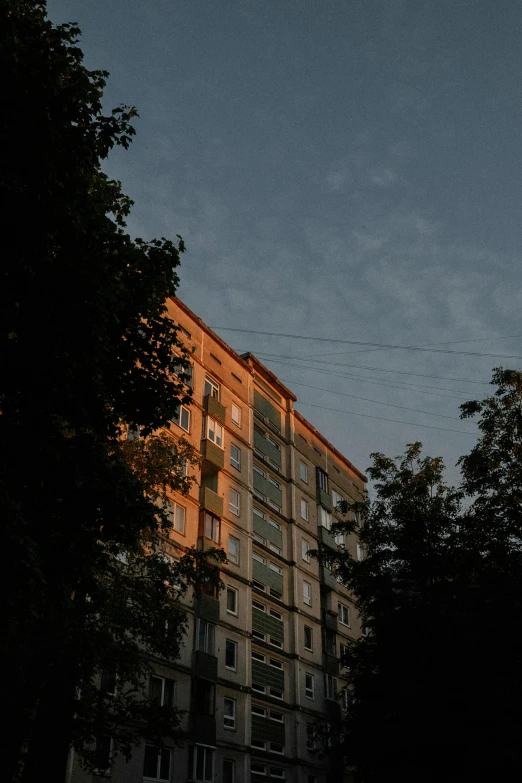 an old brick building next to some trees on a street