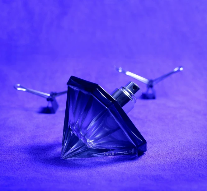 a glass object on a purple surface