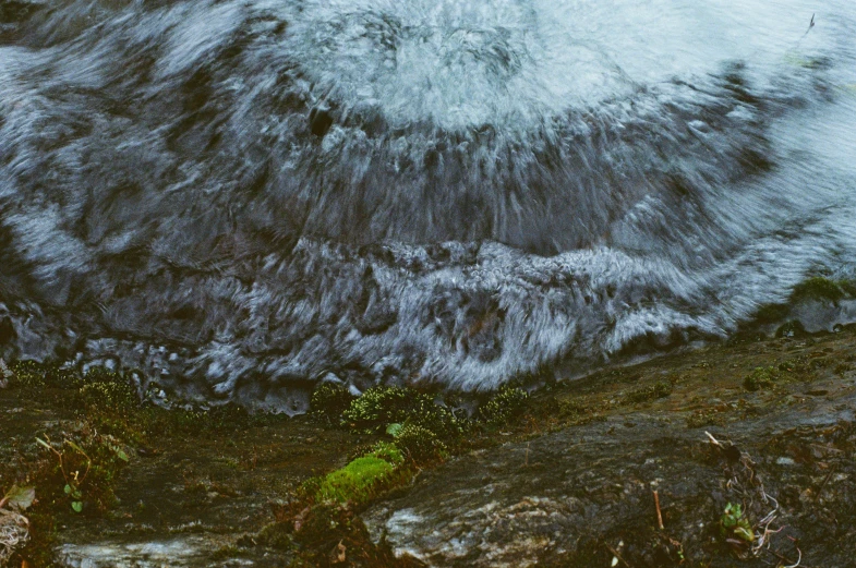 there is a wave breaking on the rocks