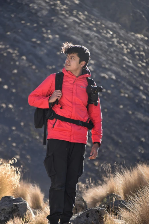 a man with a backpack is walking along a trail