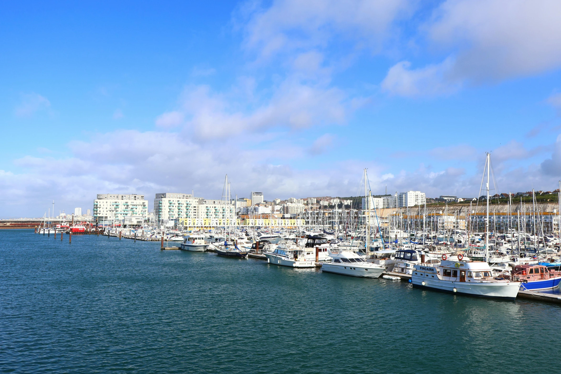 a group of boats lined up at the dock