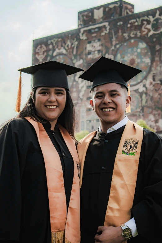 a smiling man and woman in caps and gowns