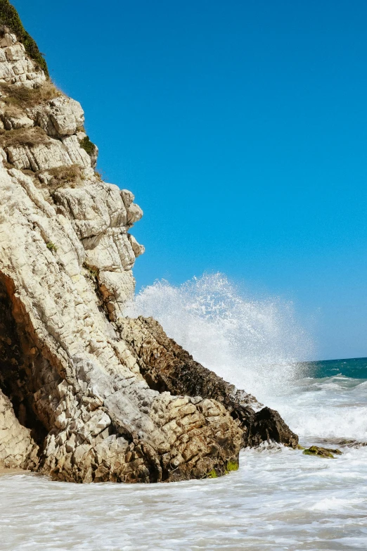 a view of water crashing along a rocky beach