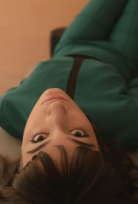 woman with brown hair looking up on the floor